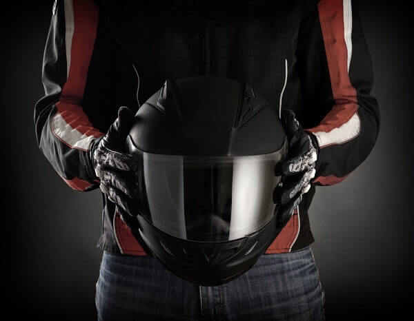 motorcycle rider holding a helmet
