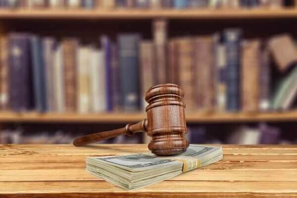 court hammer on top of money
