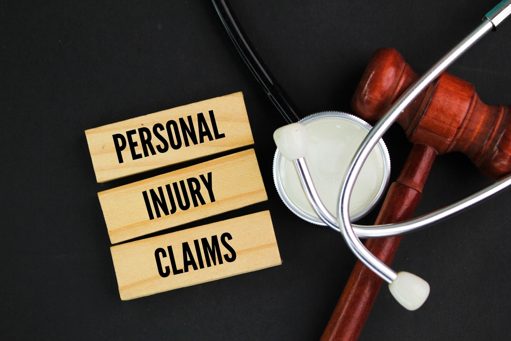 Judge’s gavel, stethoscope, and a sign reading “Personal Injury Claims”.